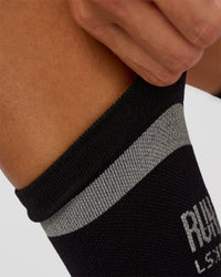 Woman wearing Run Club Fast Performance Socks 2.0 - Black-Reflective | Thumbnail Index: 4