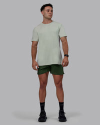 Man wearing Challenger 6" Performance Shorts - Cilantro | Thumbnail Index: 2