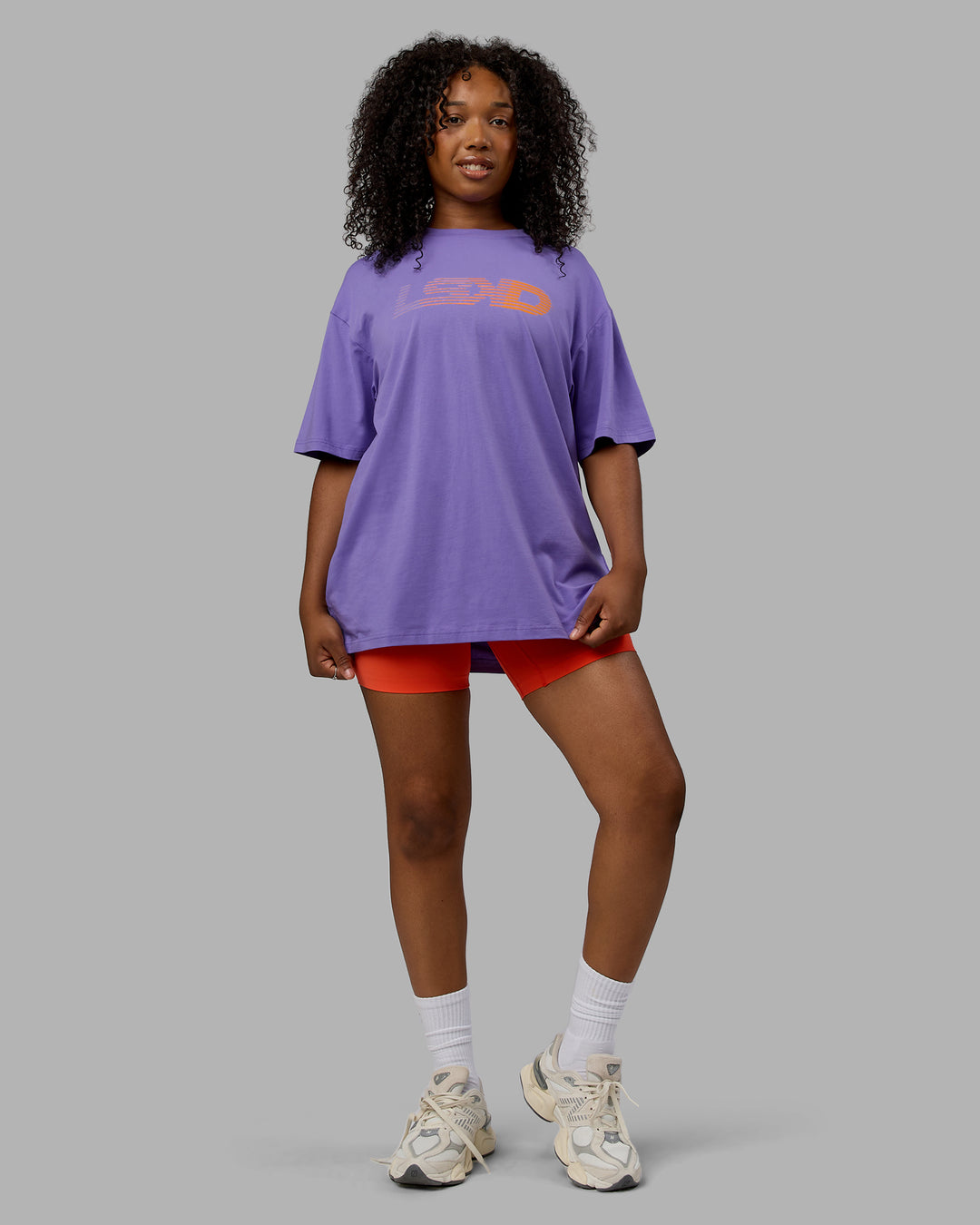 Woman wearing Unisex Motion FLXCotton Tee Oversize - Dahlia Purple-Vibrant Orange - view 11