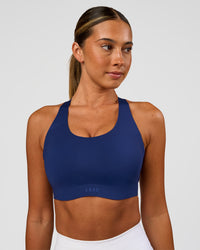 Woman wearing Stability High Support Sports Bra - Midnight Blue | Model:Charli | Size:XS (A-C Cup) | Thumbnail Index: 0
