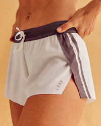 Woman wearing Accelerate 3" Force Mid-Rise Running Short - Cocoa powder-Off White | Model:Maja | Size:XS | Thumbnail Index: 0