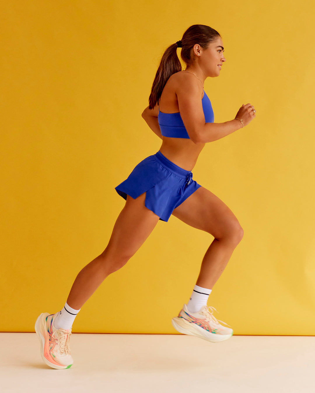 Woman wearing Accelerate 3" Mid-Rise Running Short - Electric Indigo | Set:true | Angle:closeup | Model:Bella | Size:XS - view 7