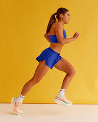 Woman wearing Accelerate 3" Mid-Rise Running Short - Electric Indigo | Set:true | Angle:closeup | Model:Bella | Size:XS | Thumbnail Index: 6