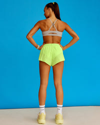 Woman wearing Accelerate 3" Running Short - Lime Glo-Shale Beige | Model:Steph | Size:XS | Thumbnail Index: 2