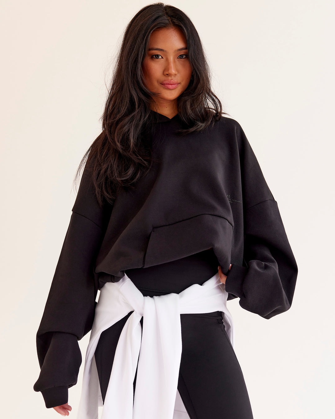 Woman wearing AfterDark ZeroCrease Oversized Hoodie - Black | Model:Loren | Size:XS - view 4