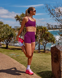 Woman wearing Elixir Defined High-Rise 4" Short - Plum Caspia | Model:Chloe | Size:XS | Thumbnail Index: 3