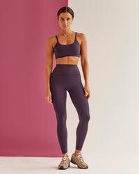 Woman wearing Elixir Ultra High-Rise Full Length Legging Pockets - Midnight Plum | Model:Bruna | Size:XS | Thumbnail Index: 1