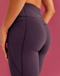 Woman wearing Elixir Ultra High-Rise Full Length Legging Pockets - Midnight Plum | Model:Bruna | Size:XS | Thumbnail Index: 2