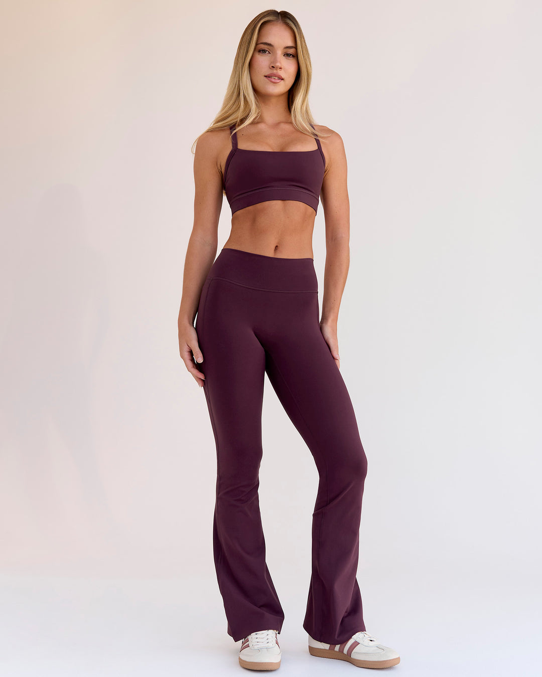 Woman wearing Fusion V-Contour High-Rise Flared Petite Legging Pockets - Cherry Lacquer | Model:Issy | Size:XS - view 1