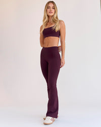Woman wearing Fusion V-Contour High-Rise Flared Petite Legging Pockets - Cherry Lacquer | Model:Issy | Size:XS | Thumbnail Index: 10