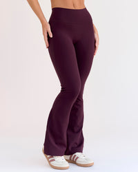 Woman wearing Fusion V-Contour High-Rise Flared Petite Legging Pockets - Cherry Lacquer | Model:Issy | Size:XS | Thumbnail Index: 9
