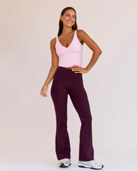 Woman wearing Fusion V-Contour High-Rise Flared Petite Legging Pockets - Cherry Lacquer | Model:Brylee | Size:XS | Thumbnail Index: 7
