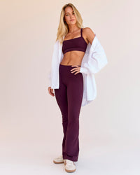 Woman wearing Fusion V-Contour High-Rise Flared Petite Legging Pockets - Cherry Lacquer | Model:Issy | Size:XS | Thumbnail Index: 2