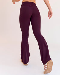 Woman wearing Fusion V-Contour High-Rise Flared Petite Legging Pockets - Cherry Lacquer | Model:Issy | Size:XS | Thumbnail Index: 3