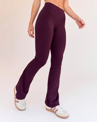 Woman wearing Fusion V-Contour High-Rise Flared Petite Legging Pockets - Cherry Lacquer | Model:Issy | Size:XS | Thumbnail Index: 6