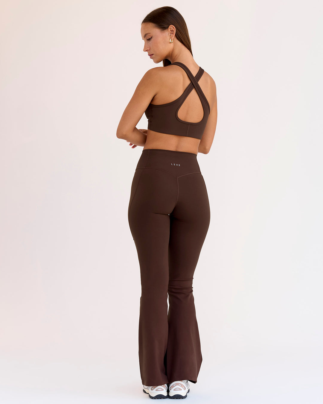Woman wearing Fusion V-Contour High-Rise Flared Petite Legging Pockets - Hot Chocolate | Model:Brylee | Size:XS - view 3