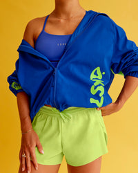 Woman wearing Hype Oversized Track Jacket - Electric Indigo | Model:Bella | Size:XS | Thumbnail Index: 0