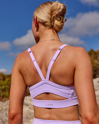 Woman wearing Momentum Sports Bra - Pale Lilac | Model:Kait | Size:XS | Thumbnail Index: 1