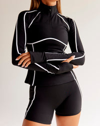 Woman wearing Power Quarter Zip Jacket - Black | Model:Charli | Size:XS | Thumbnail Index: 2