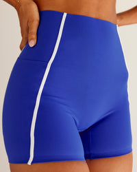 Woman wearing Power Ultra High-Rise 4" Short Pockets - Electric Indigo | Model:Charli | Size:XS | Thumbnail Index: 0
