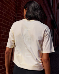 Woman wearing Shadow Mode FLXCotton Oversized Tee - Off White Washed | Model:Alex | Size:XS | Thumbnail Index: 1