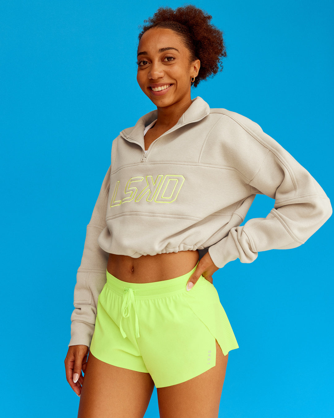 Woman wearing Slam Quarter Zip Sweater - Shale Beige-Lime Glo | Model:Txai | Size:XS - view 1