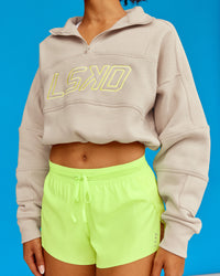 Woman wearing Slam Quarter Zip Sweater - Shale Beige-Lime Glo | Model:Txai | Size:XS | Thumbnail Index: 1
