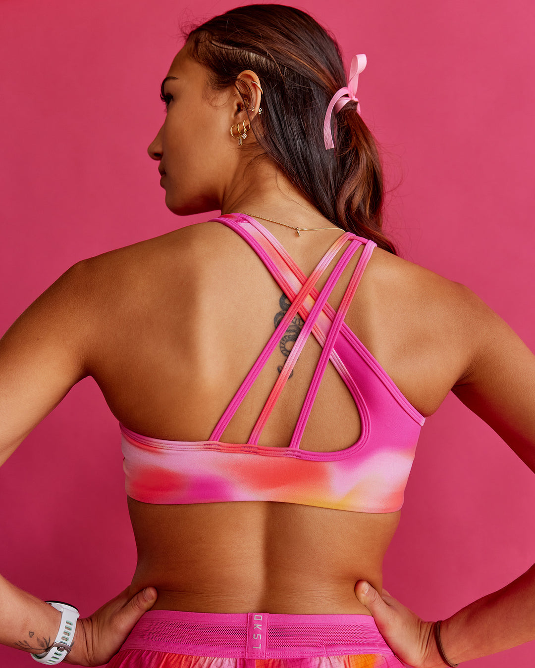 Woman wearing Stamina Rise Sports Bra - Pink Glow Print | Model:Steph | Size:XS - view 1