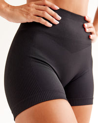 Woman wearing Surge Seamless High-Rise 4" Short - Black | Model:Brylee | Size:XS | Thumbnail Index: 0