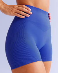 Woman wearing Surge Seamless High-Rise 4" Short - Power Cobalt | Model:Brylee | Size:XS | Thumbnail Index: 1