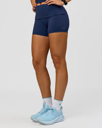 Woman wearing Groovy High Rise Fold Over 4" Short - Future Navy | Model:Grace | Size:XS | Thumbnail Index: 6