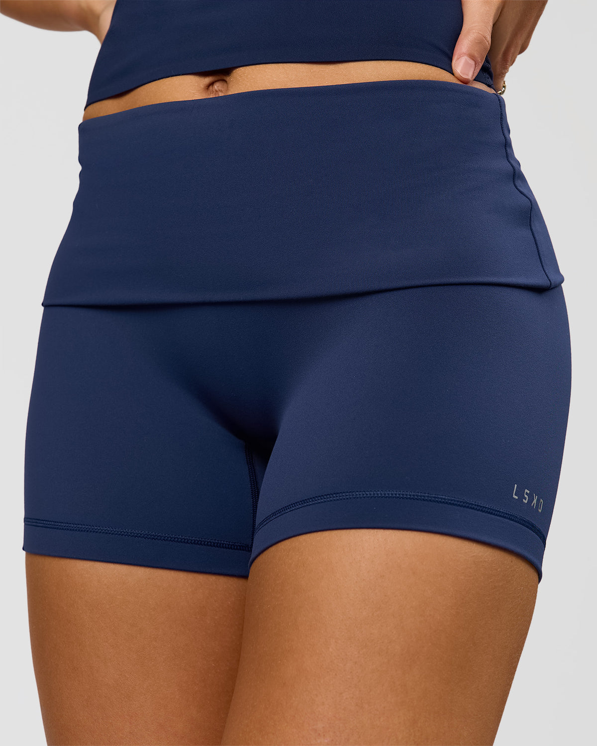 Woman wearing Groovy High Rise Fold Over 4" Short - Future Navy | Model:Grace | Size:XS