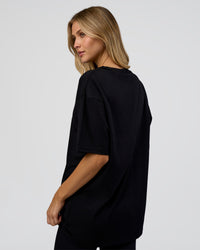 Woman wearing 1% Better Every Day EST FLXCotton Oversized Tee - Black | Model:Leilani | Size:XS | Thumbnail Index: 5