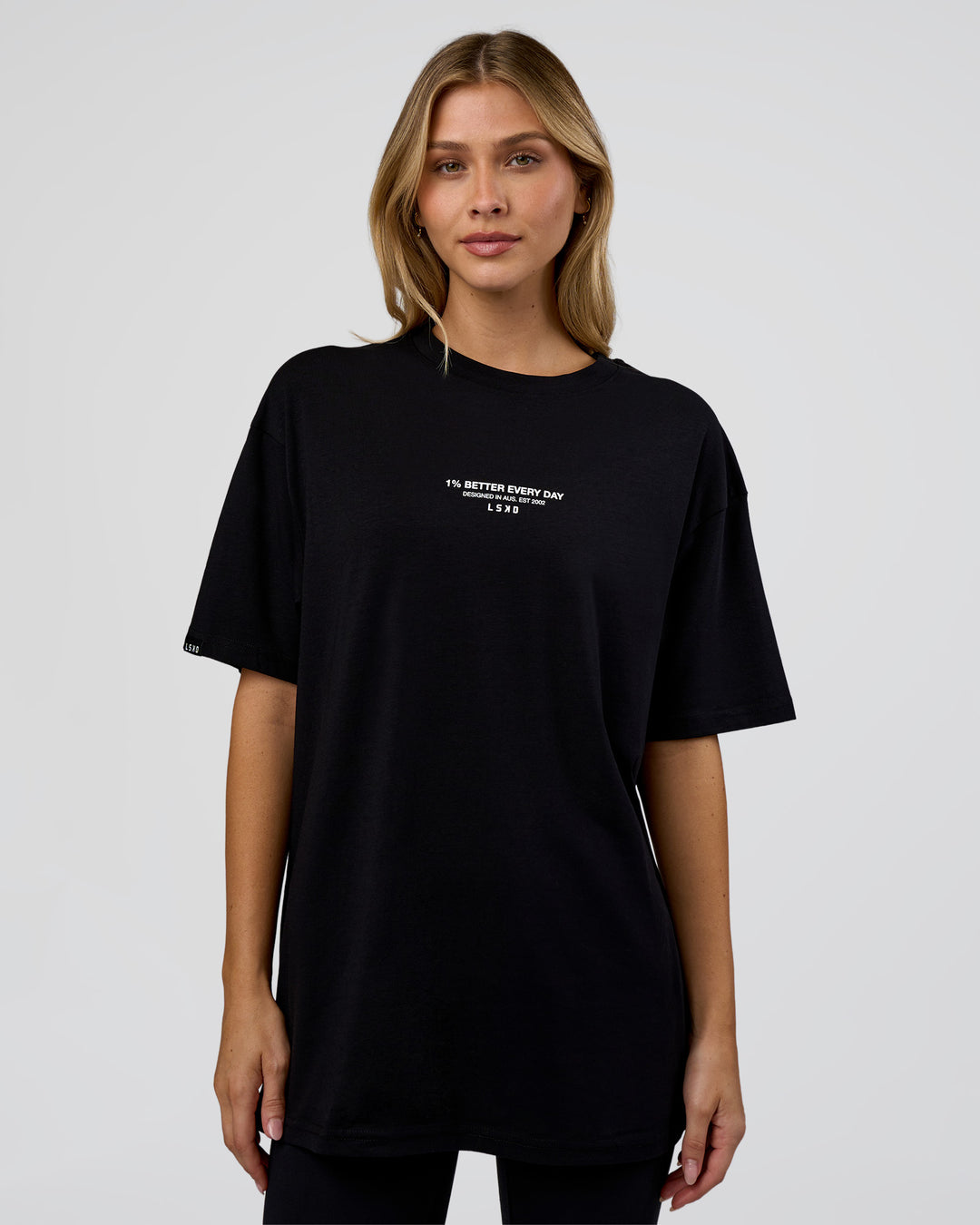 Woman wearing 1% Better Every Day EST FLXCotton Oversized Tee - Black | Model:Leilani | Size:XS - view 4