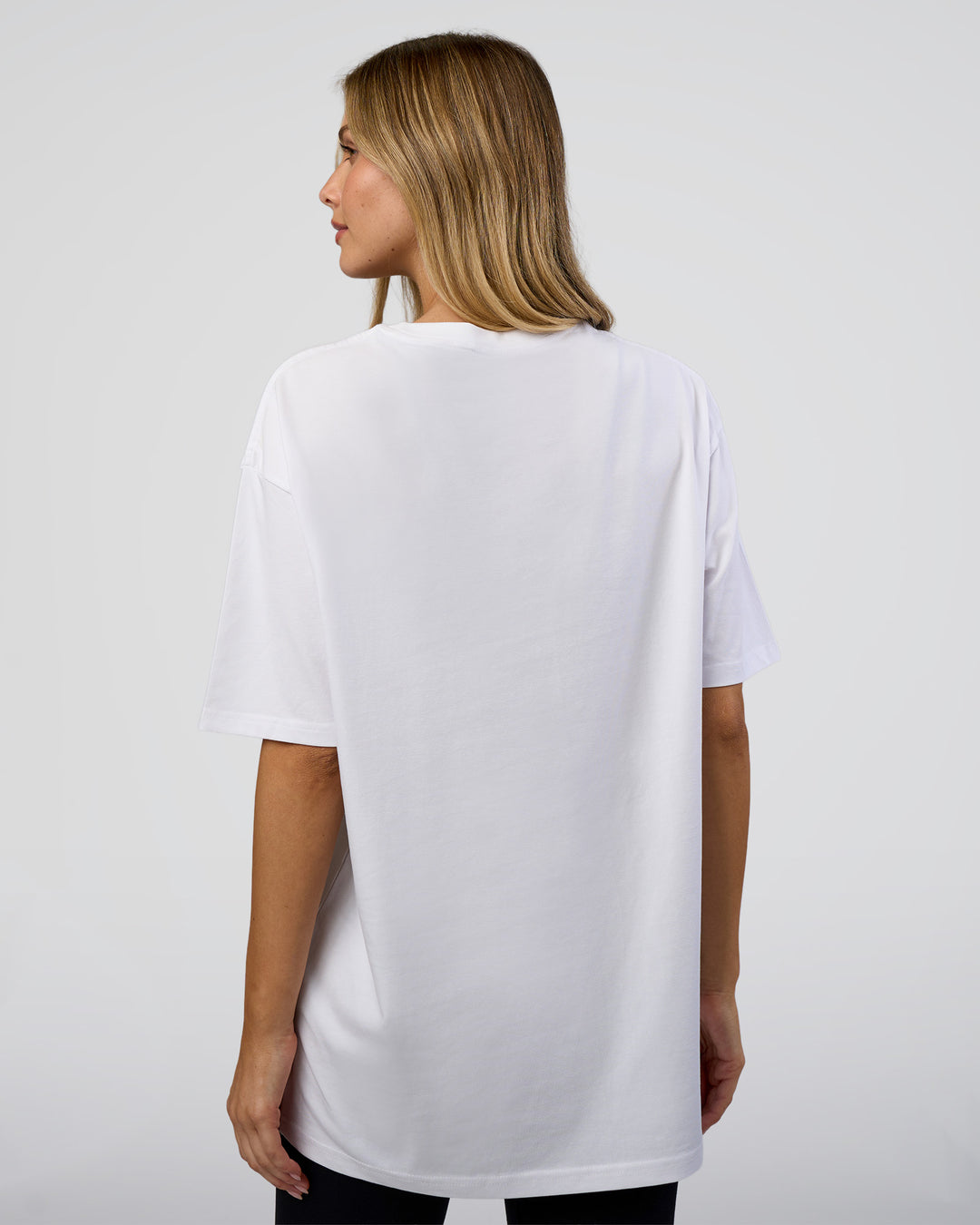 Woman wearing 1% Better Every Day EST FLXCotton Oversized Tee - White | Model:Leilani | Size:XS - view 7