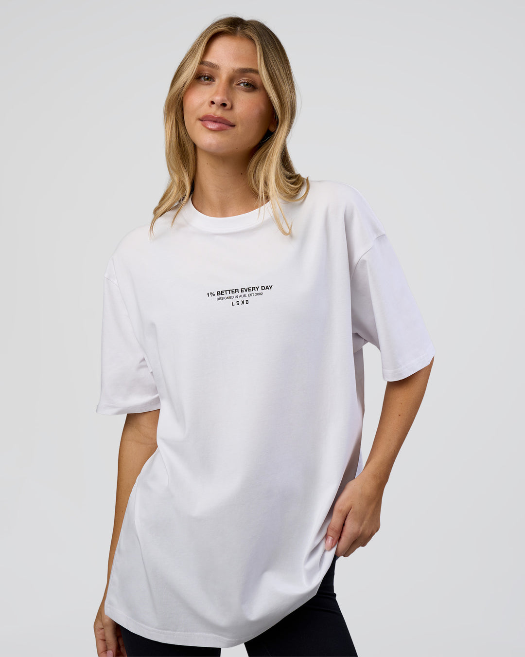 Woman wearing 1% Better Every Day EST FLXCotton Oversized Tee - White | Model:Leilani | Size:XS - view 4