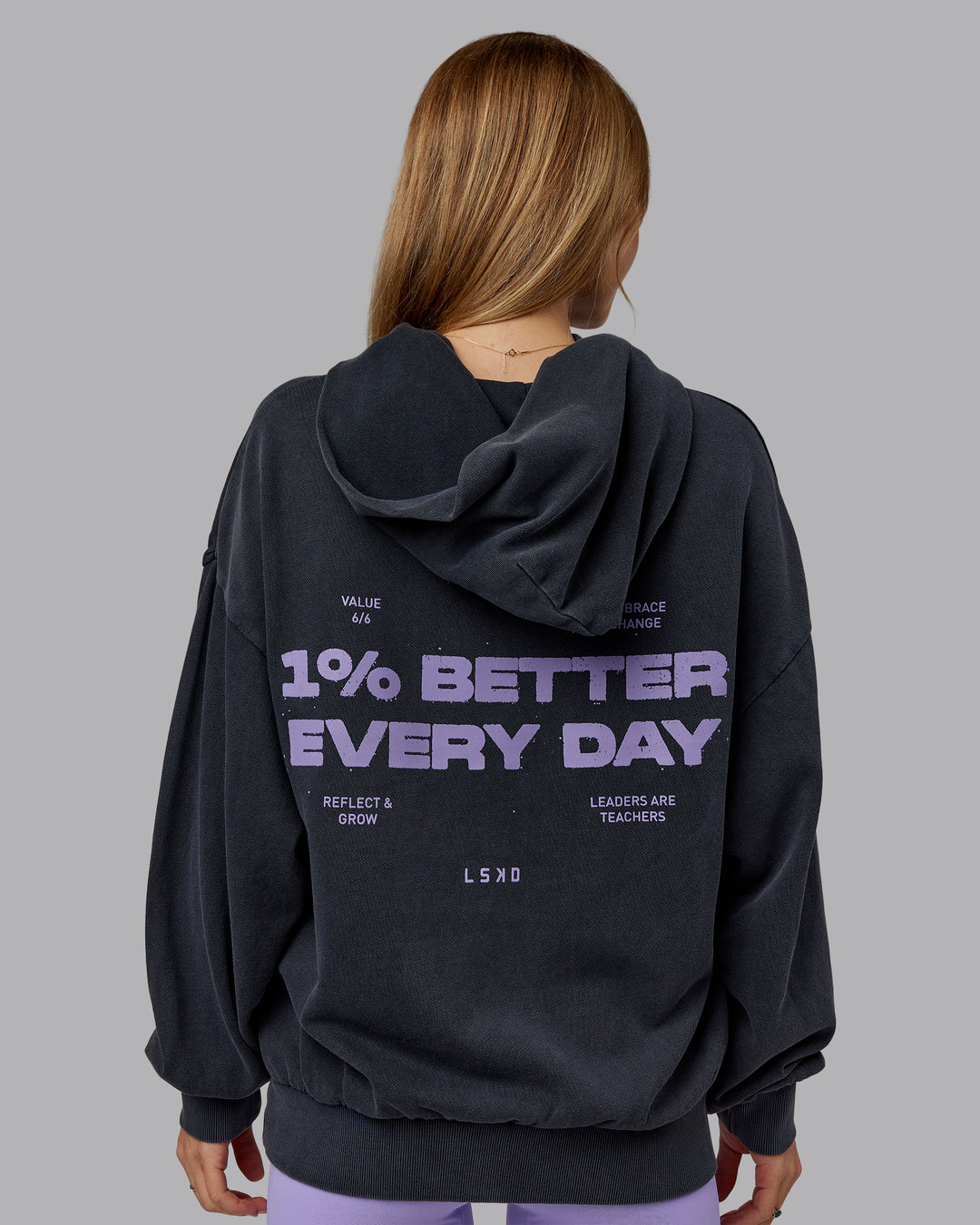 Woman wearing 1% Better Value Series Oversized Hoodie - Black-Violet Ray | Model:Emilie | Size:XS - view 2