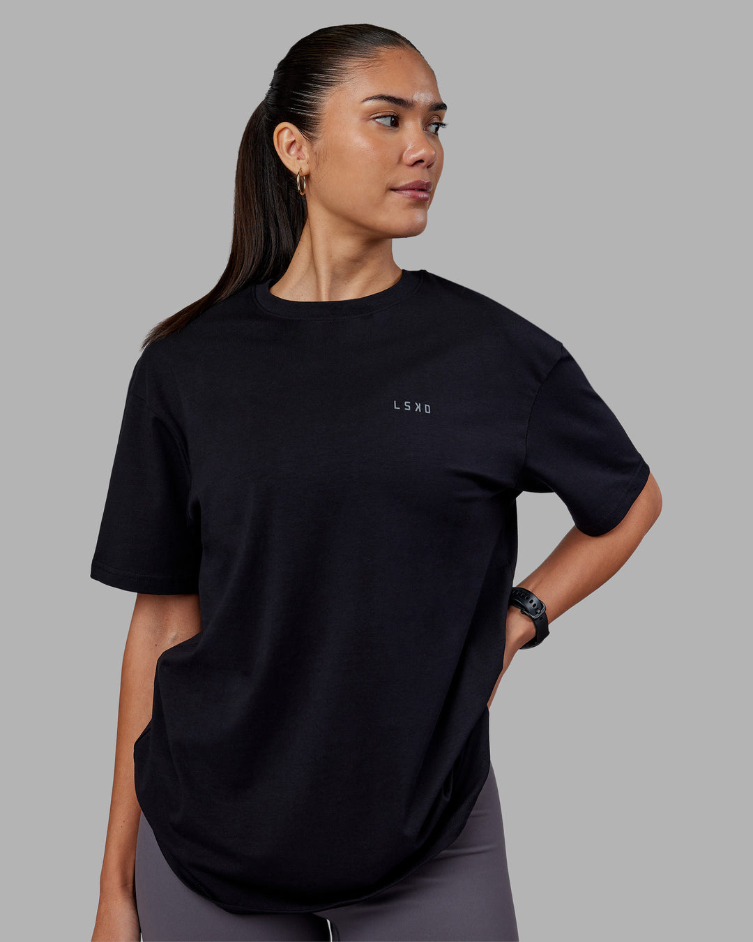 Woman wearing 1% Better Value Series FLXCotton Tee Oversize - Black-Black | Model:Rhiley | Size:XS - view 4