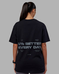 Woman wearing 1% Better Value Series FLXCotton Tee Oversize - Black-Black | Model:Rhiley | Size:XS | Thumbnail Index: 2