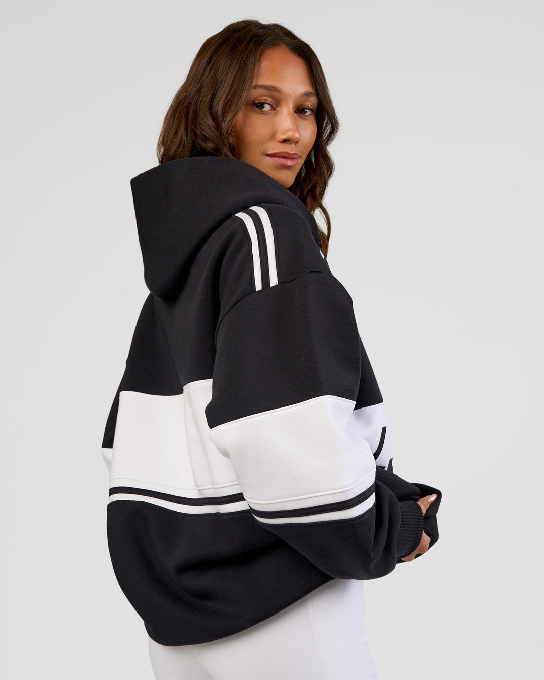 Woman wearing A-Team Oversized Hoodie - Caviar-White | Model:Dakota | Size:XS - view 12