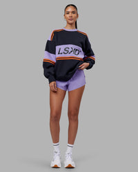 Woman wearing A-Team Sweater Oversize - Caviar-Violet Ray | Model:Rhiley | Size:XS | Thumbnail Index: 1