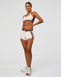 Woman wearing Accelerate 3" Force Mid-Rise Running Short - Cocoa powder-Off White | Model:Charli | Size:XS | Thumbnail Index: 7