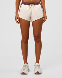 Woman wearing Accelerate 3" Force Mid-Rise Running Short - Cocoa powder-Off White | Set:true | Angle:front | Model:Charli | Size:XS | Thumbnail Index: 1