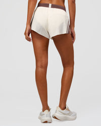 Woman wearing Accelerate 3" Force Mid-Rise Running Short - Cocoa powder-Off White | Set:true | Angle:back | Model:Charli | Size:XS | Thumbnail Index: 4