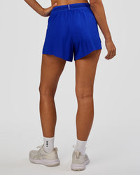 Woman wearing Accelerate 3" High-Rise Running Short - Electric Indigo | Set:true | Angle:back | Model:Brylee | Size:XS | Thumbnail Index: 2