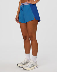 Woman wearing Accelerate 3" High-Rise Running Short - Electric Indigo-Multi | Set:true | Angle:side | Model:Brylee | Size:XS | Thumbnail Index: 1