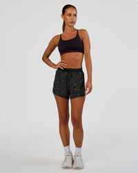 Woman wearing Accelerate 3" High-Rise Running Short - Energy Print Black | Model:Brylee | Size:XS | Thumbnail Index: 2