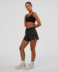 Woman wearing Accelerate 3" High-Rise Running Short - Energy Print Black | Model:Brylee | Size:XS | Thumbnail Index: 3