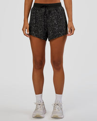 Woman wearing Accelerate 3" High-Rise Running Short - Energy Print Black | Set:true | Angle:front | Model:Brylee | Size:XS | Thumbnail Index: 6