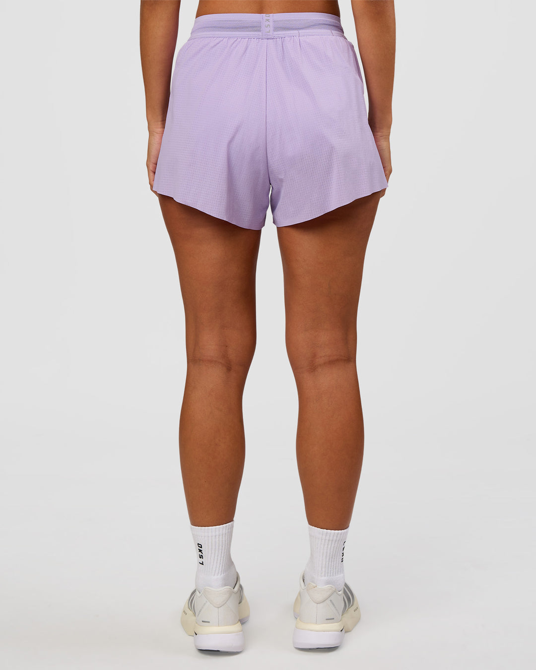Woman wearing Accelerate 3" High-Rise Running Short - Pale Lilac | Set:true | Angle:back | Model:Brylee | Size:XS - view 4